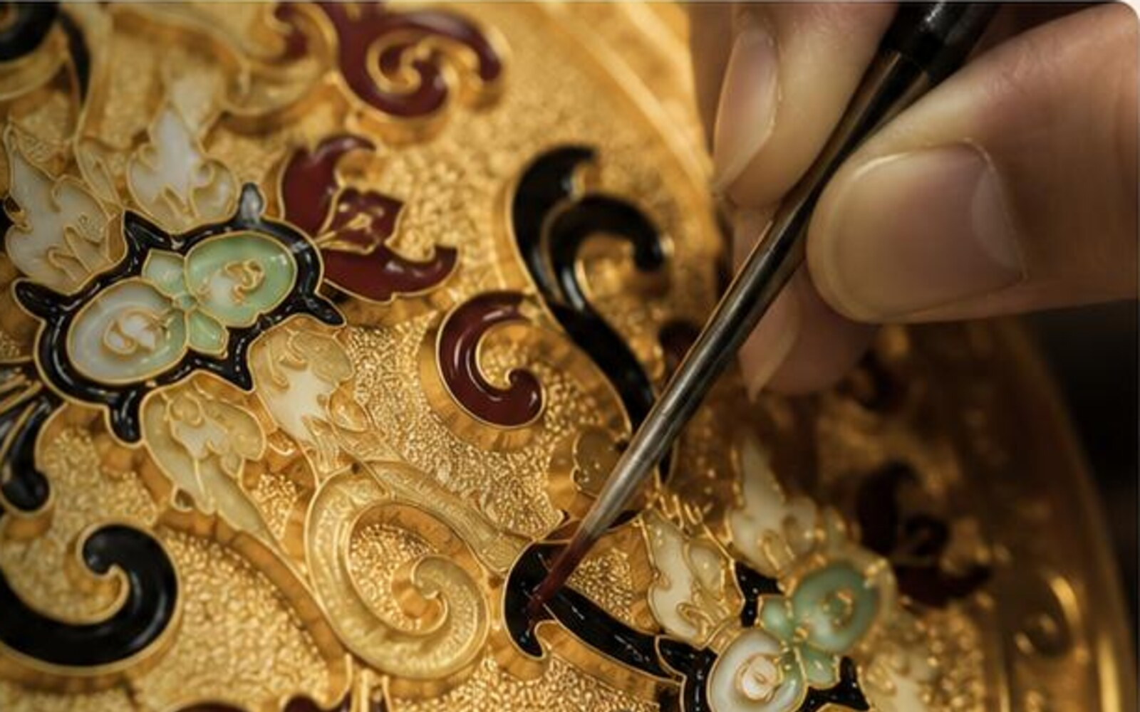 Coloured detailing applied to a gold masterpiece